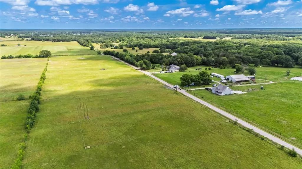 Aerial view of open land and rural road